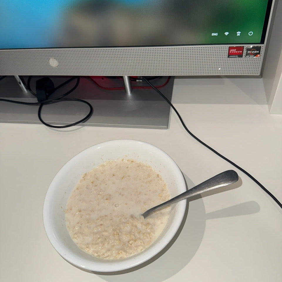 Plain Oats Bowl Next to Computer on office desk